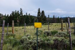 A totally innocuous sign on a tiny fenced off area of the prairie.